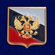 Значок с гербом России на фоне флага
